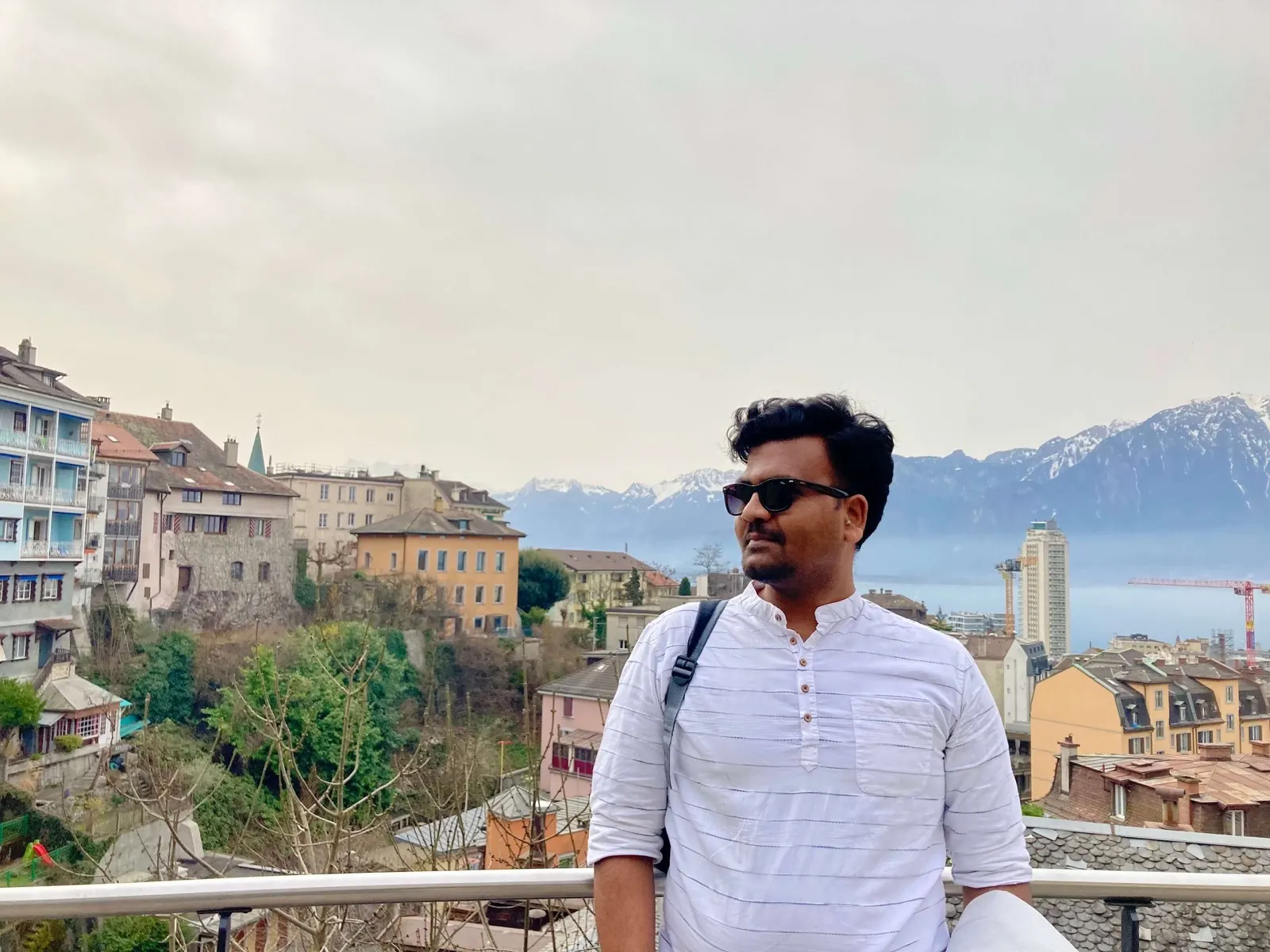 Pancham overlooking a Swiss lakeside town and mountains